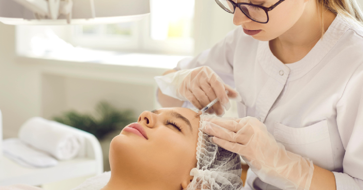Practitioner giving Sculptra injection to woman in Houston, TX