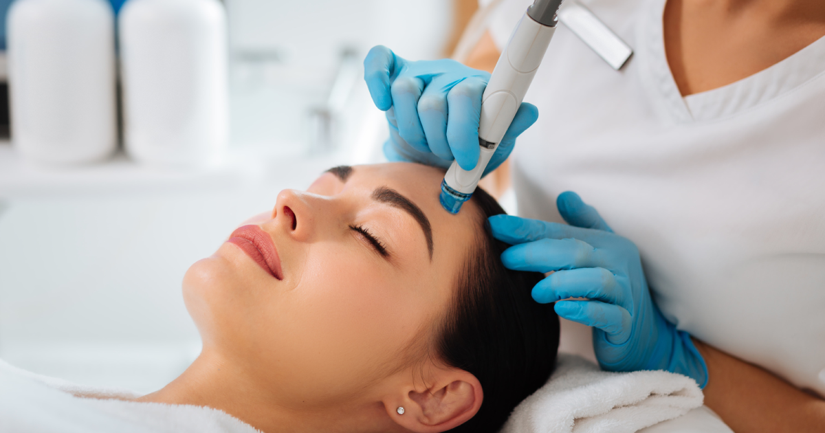 Woman receiving HydraFacial treatment at a spa clinic in Houston, TX